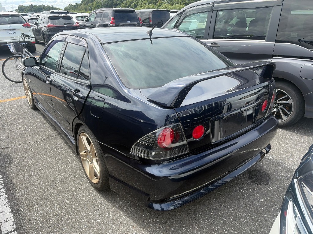 Rear-left view of a Toyota Altezza at USS showing rear spoiler and Altezza-style taillights