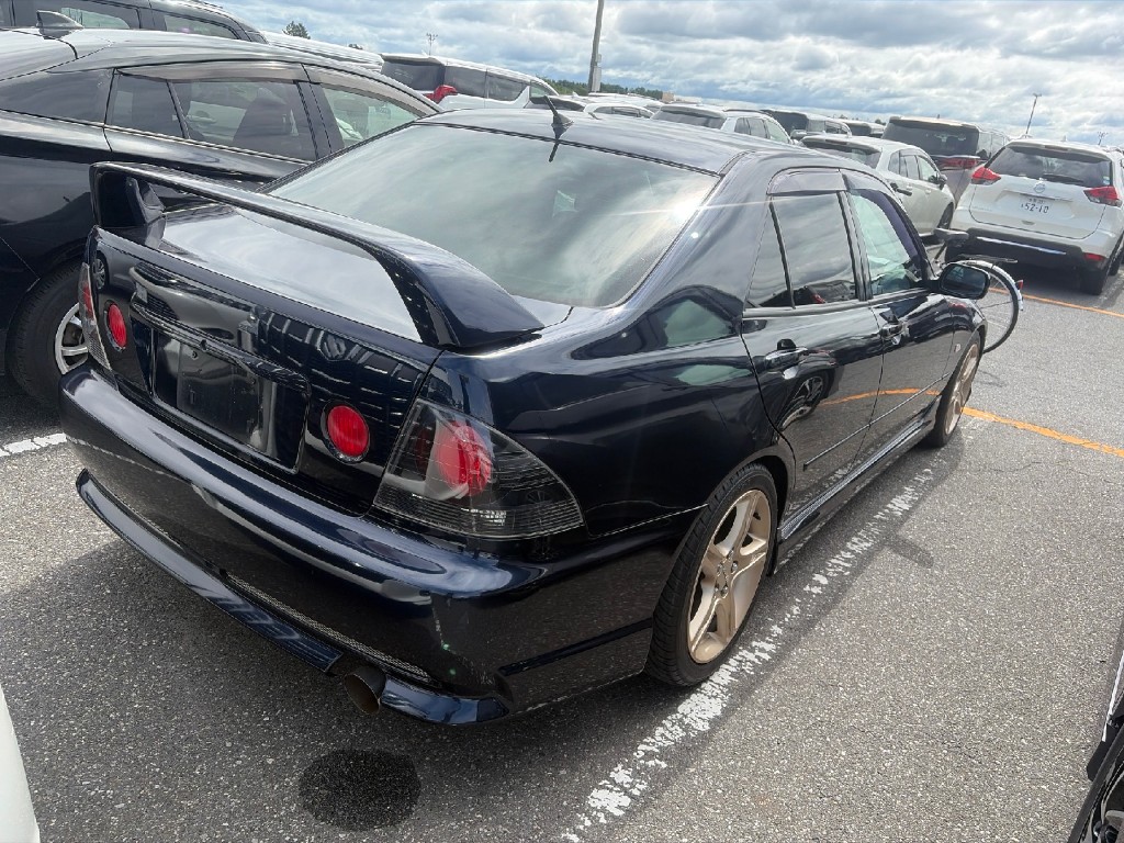 Rear-right view of a Toyota Altezza at USS auction lot