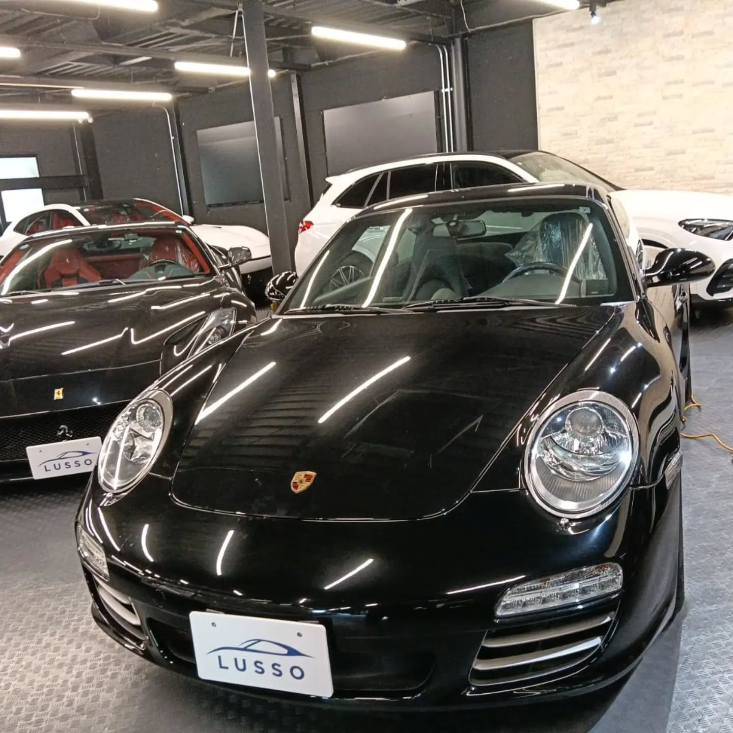 Black Porsche 911 997 Carrera 4S front three-quarter view after July import
