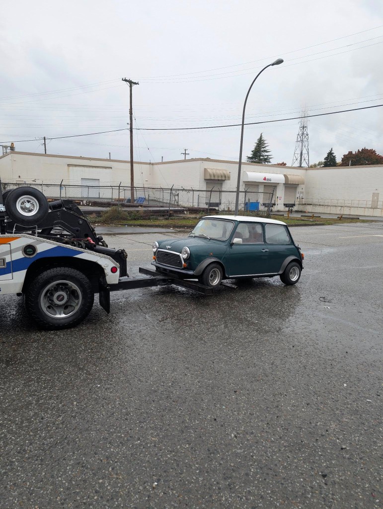 Classic Rover Mini being towed for delivery in Vancouver